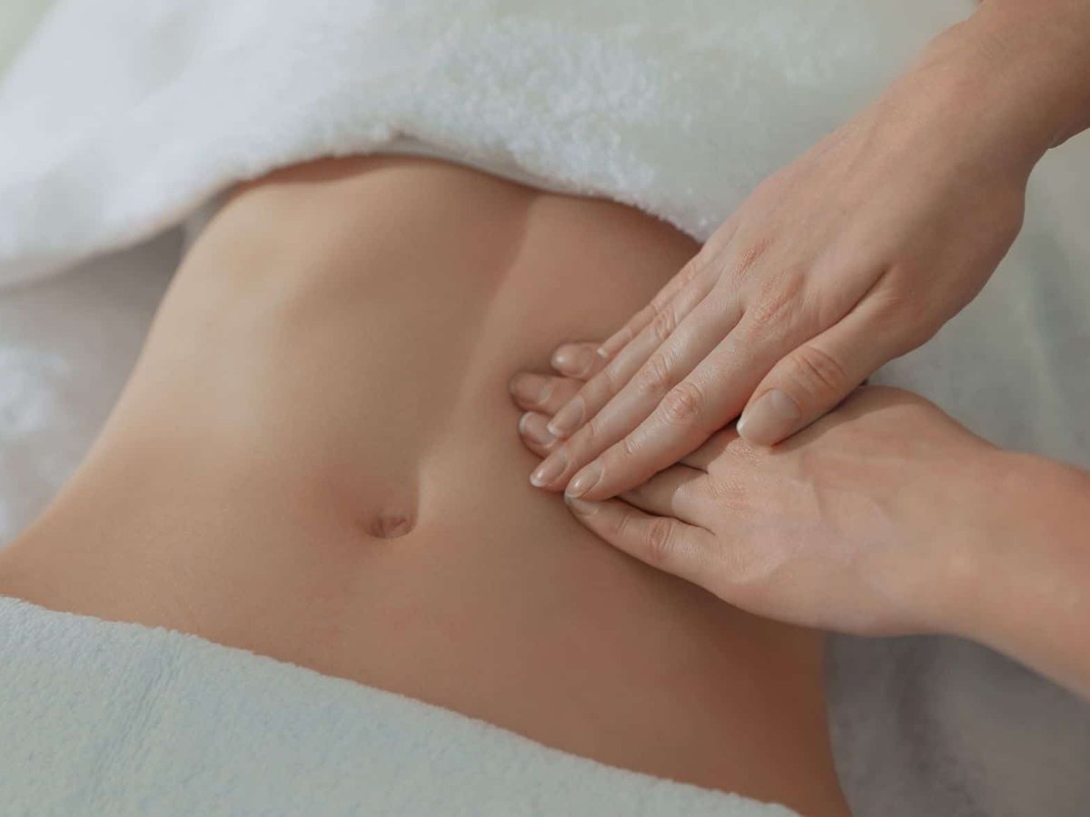 Abdominal manual lymphatic drainage during a monthly wellness session