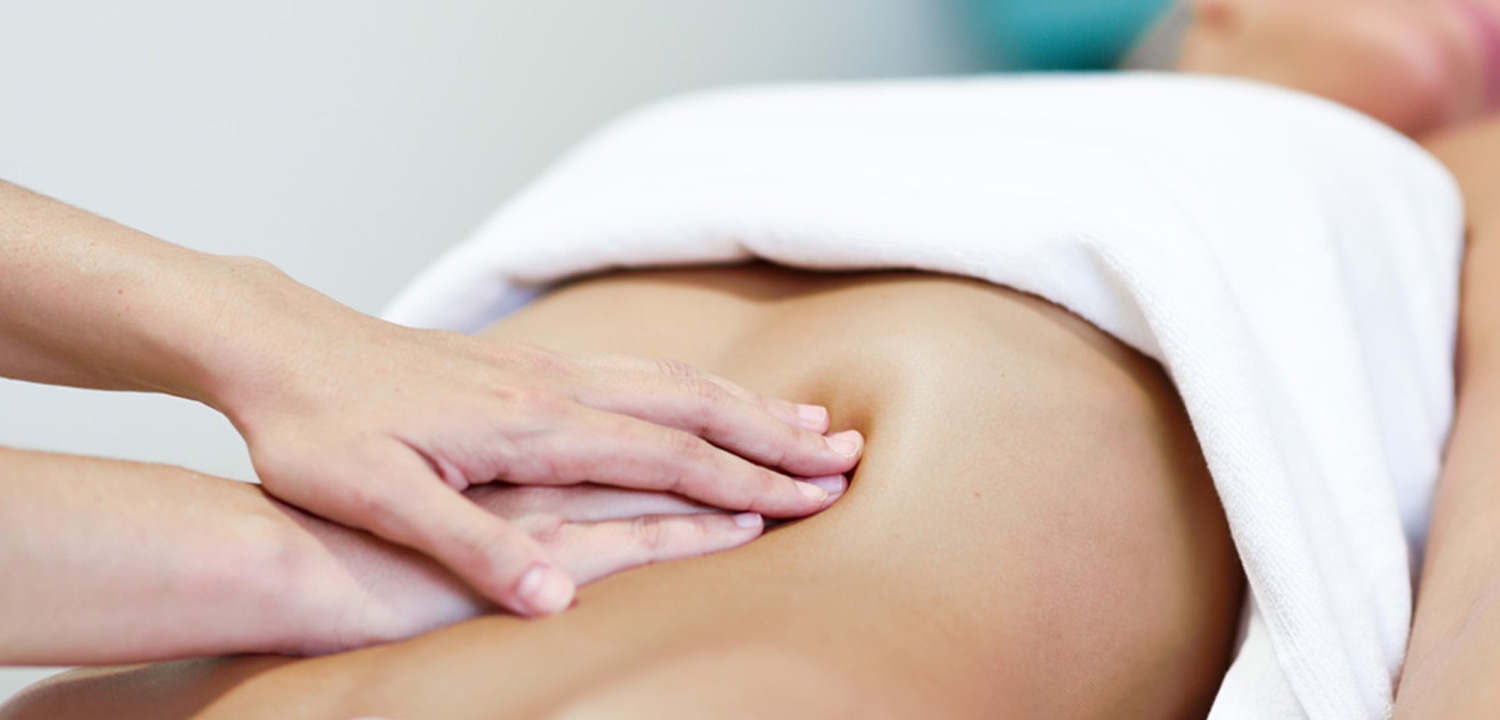 Light, flat-handed abdominal lymphatic drainage with the sheet folded at the waist